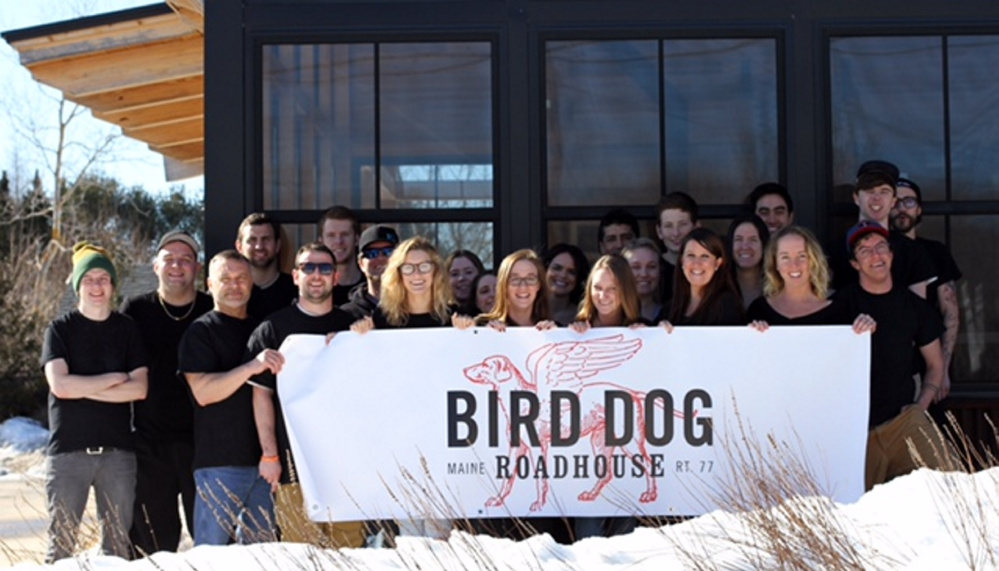 The team at the Bird Dog Roadhouse, formerly known as Rudy's of the Cape, shows off its new sign.