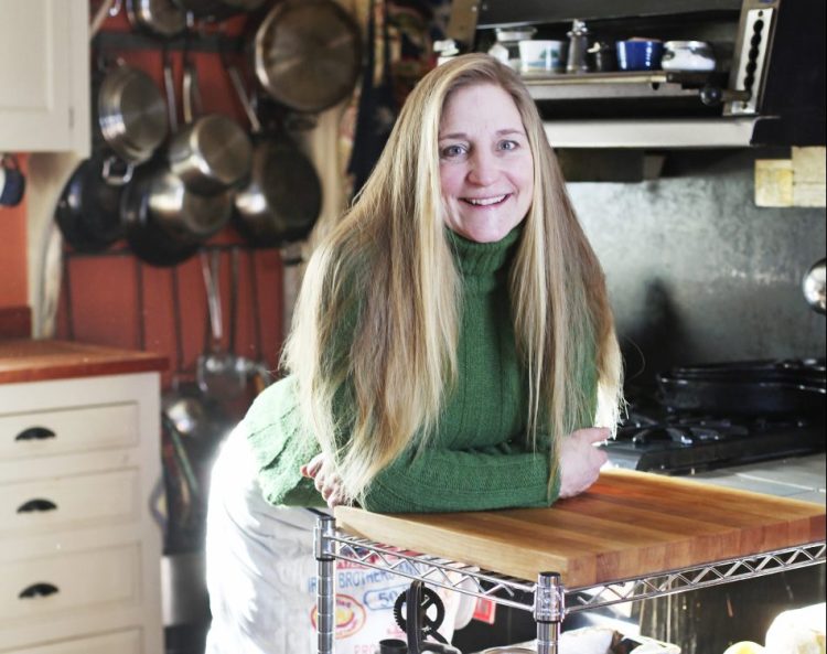 Annie Mahle in her kitchen at home in Rockland. Mahle has recently self-published the second cookbook in her "Sugar & Salt" series.