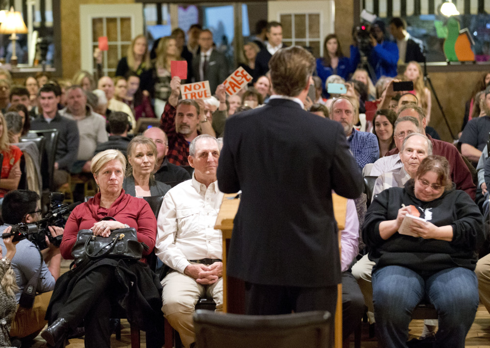 U.S. Rep. Dave Brat, R-Va., with his back to the camera, answers questions during a town hall meeting with constituents in Blackstone, Va., on Tuesday.
