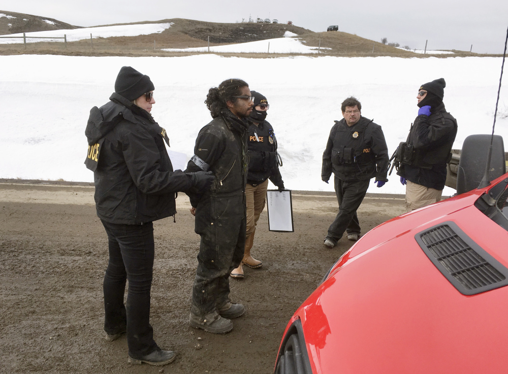 Authorities arrest one of the last remaining holdouts from the now-closed Dakota Access pipeline protest camp in southern North Dakota near Cannon Ball on Thursday. Police made about several dozen arrests, and declared the camp cleared.