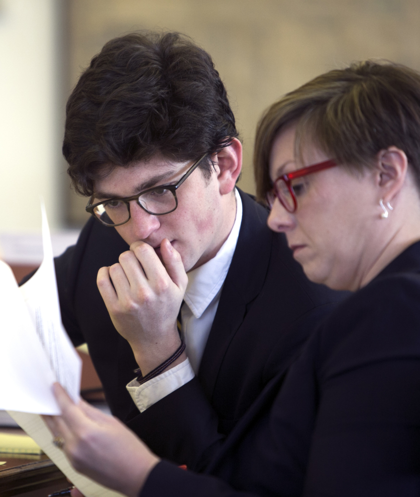 Owen Labrie and his attorney look over documents during the hearing in Concord, N.H., on whether Labrie should be granted a retrial.