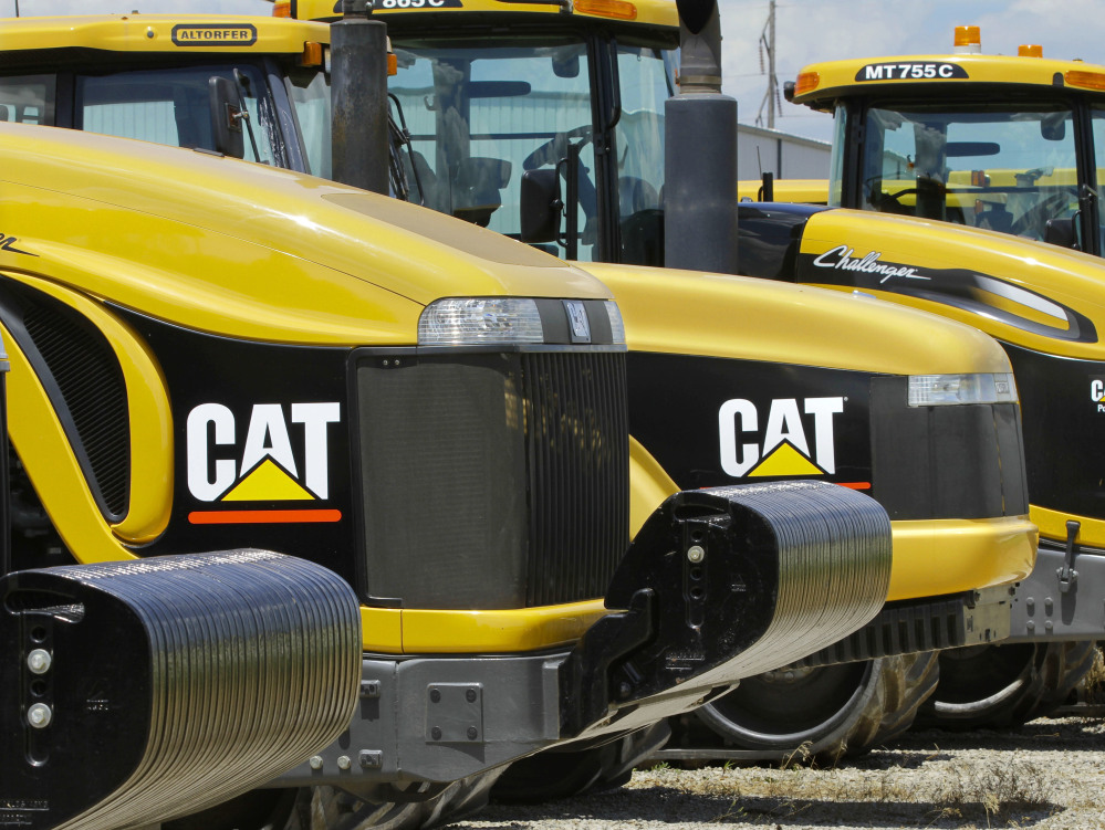 Caterpillar Inc., based in Peoria, Ill., makes earth-moving equipment like these tractors on a lot in Clinton, Ill. The company's recent decision to move 300 top headquarters jobs to the Chicago area left Peoria with a vacuum to fill.