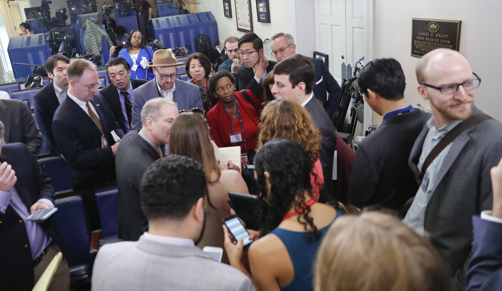 Reporters line up for a briefing in press secretary Sean Spicer's office at the White House on Friday. The White House held an off-camera briefing in Spicer's office, selecting who could attend.