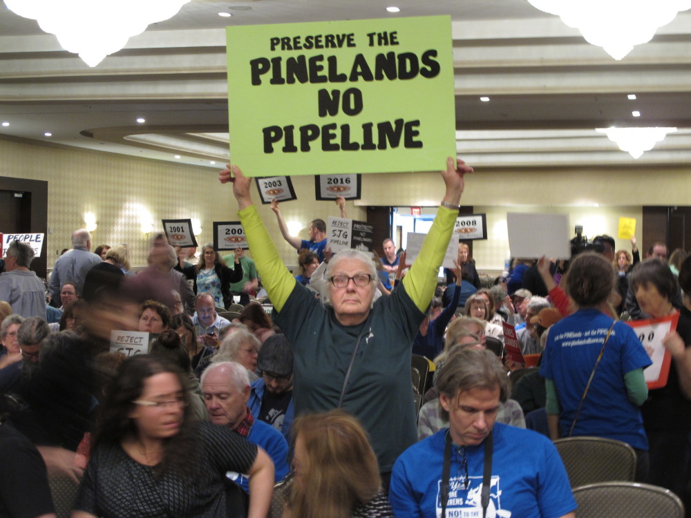 Opponents of a proposed natural gas line that would run through New Jersey's federally protected Pinelands reserve gather inside a hotel in Cherry Hill, N.J., on Friday before a Pinelands Commission meeting at which the proposal was approved.