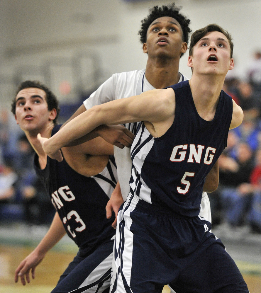 Yarmouth's NaJee McQueen, center, battles with John Villanueva, left, and Tanner Mann of Gray-New Gloucester during Yarmouth's win Feb. 18. A reader praises this photo for showing "their emotions as well as the court action."