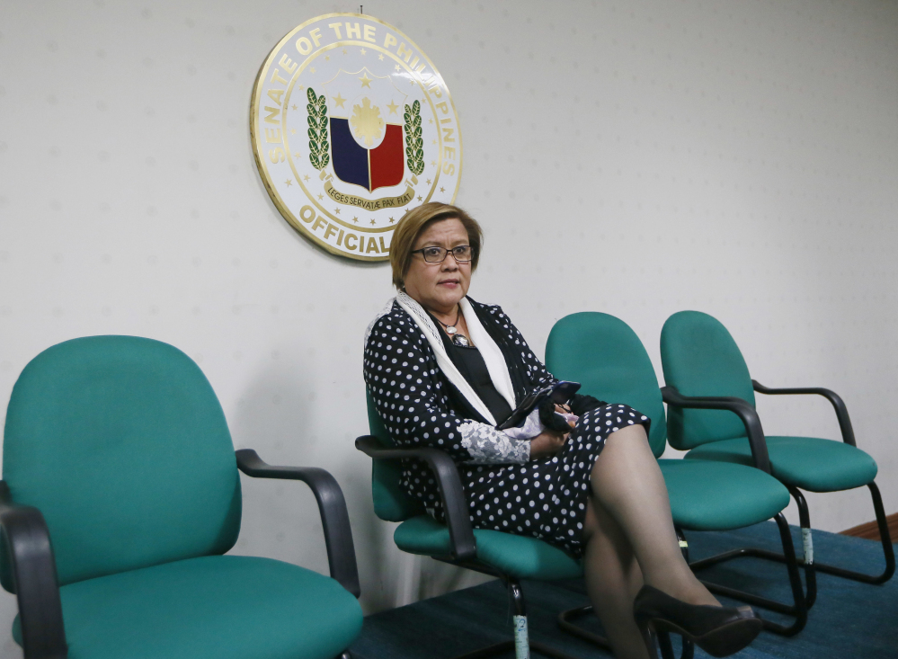 Opposition Senator Leila de Lima waits for her fellow senators prior to addressing the media after a warrant for her arrest was issued by a regional trial court Thursday, Feb. 23, 2017, in suburban Pasay city, south of Manila, Philippines. The Philippine court has issued an arrest warrant on drug charges for the senator and former top human rights official who is one of the most vocal critics of President Rodrigo Duterte and his deadly crackdown on illegal drugs. De Lima has vehemently denied the charges, which she says are part of Duterte's attempt to intimidate critics of his crackdown, which has left more than 7,000 drug suspects dead. (AP Photo/Bullit Marquez)