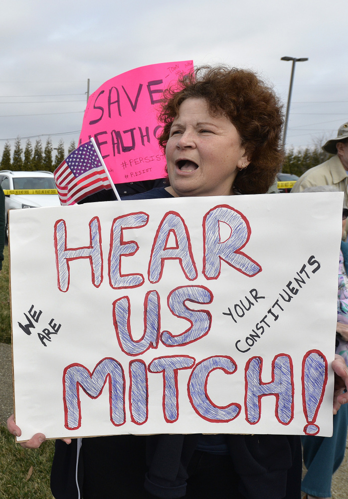 A crowd protests against Senate Majority Leader Mitch McConnell in Jeffersontown, Ky., on Wednesday.
