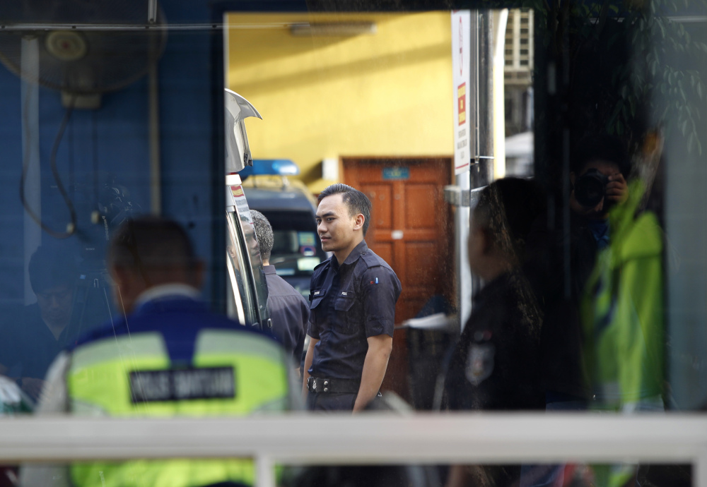 Police officers stay inside the guard post of the forensic department at Kuala Lumpur Hospital in Kuala Lumpur, Malaysia, on Saturday. According to police Friday, forensics stated that the banned chemical weapon VX nerve agent was used to kill Kim Jong Nam, the North Korean ruler's outcast half brother who was poisoned last week at the airport.
