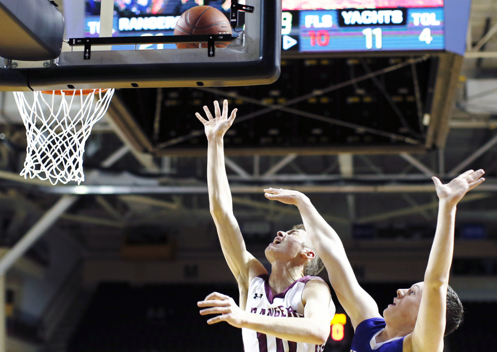 Greely's Ryan Twitchell sneaks past Emmett Hamilton of Falmouth during the Class A South boys' basketball final Saturday night at Cross Insurance Arena. Twitchell led top-ranked Greely to a 47-26 victory.