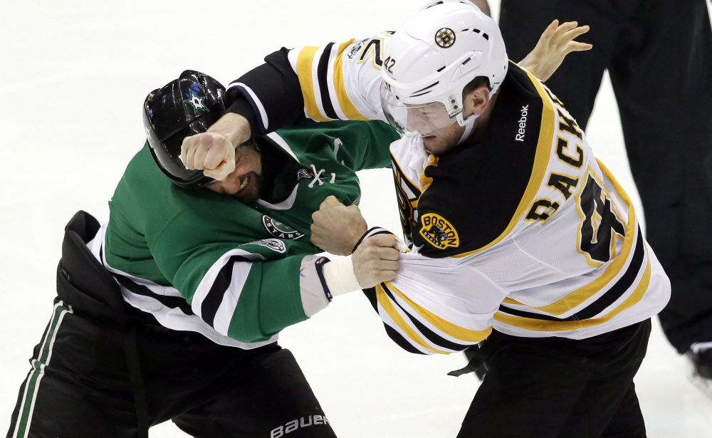 Bruins right wing David Backes (42) and Dallas Stars left wing Jamie Benn (14) fight during the first period. (Associated Press/LM Otero)
