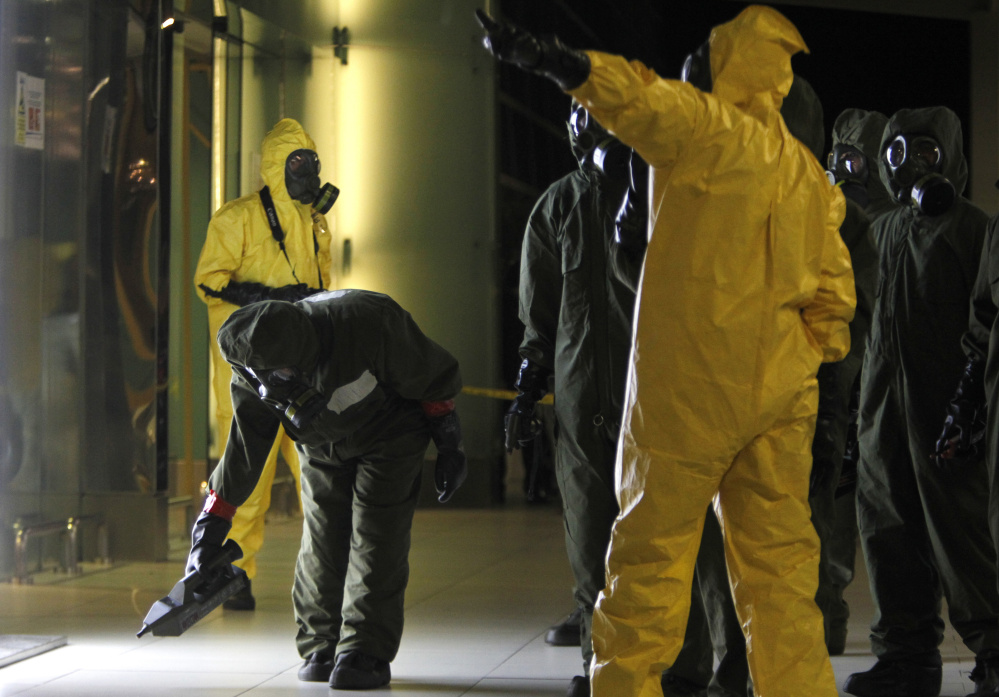 A hazardous materials crew scans the decontamination zone Sunday at Kuala Lumpur International Airport 2 in Sepang, Malaysia, where Kim Jong Un's half brother was attacked with a lethal poison. After the two-hour sweep, a police official said the terminal is "free from any form of contamination" and declared it a "safe zone."