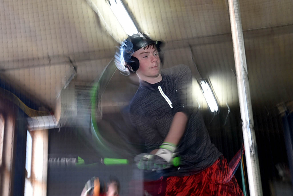Gage Morgan, 14, of Skowhegan, takes his cuts in the batting cage installed in the upstairs of the LaCasse Bats building at 4 Madison Ave. in Skowhegan.