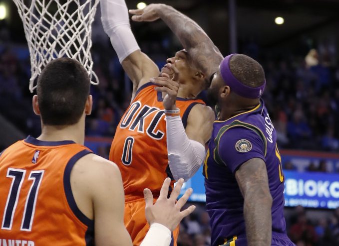 Oklahoma City guard Russell Westbrook is fouled by New Orleans forward DeMarcus Cousins, right, during the Thunder's 118-110 win Sunday in Oklahoma City.