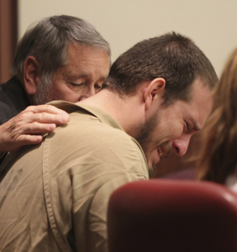 Attorney Jim Berry places his hand on the back of Jose Torres during his sentencing in Douglasville, Georgia, on Monday.