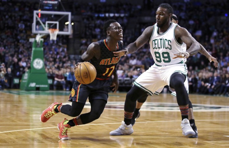 Hawks guard Dennis Schroder drives to the basket against Celtics forward Jae Crowder in the first quarter of Monday night's game in Boston. The Hawks pulled away in the second half to win easily, 114-98.