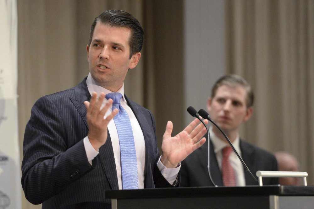 Donald Trump Jr., left, speaks as his brother Eric looks on during the grand opening of the Trump International Hotel and Tower in Vancouver, B.C., on Tuesday.