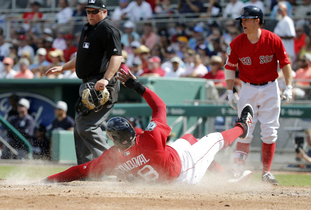 Pablo Sandoval slides into home as he scores in the second inning Tuesday against the New York Yankees at JetBlue Park in Fort Myers, Fla. Sandoval had two hits in the game is hitting .333 this spring.