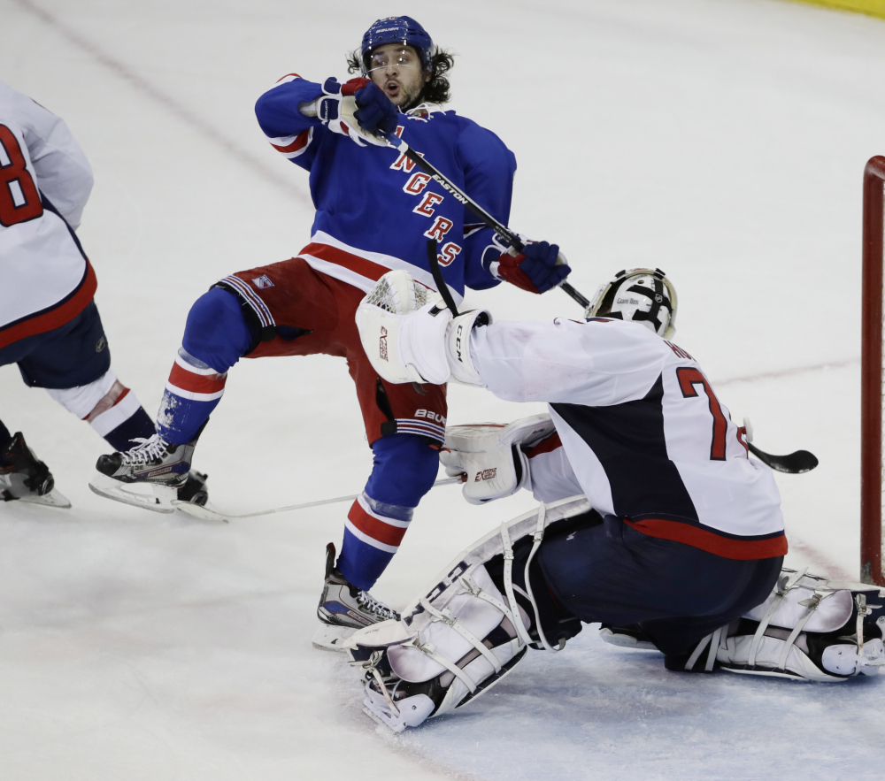 Mats Zuccarello of the Rangers trips over Washington Capitals goalie Braden Holtby in the third period Tuesday night in New York. The Capitals won 4-1.