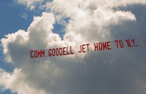 A plane tows a banner with the message "Comm. Goodell Jet Home to N.Y." as it flies over Biddeford Municipal Airport on Aug. 2, 2015. 