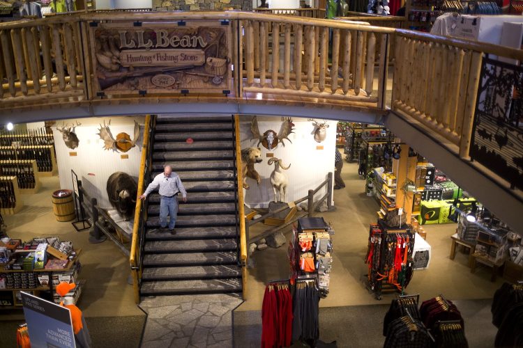 An employee walks down the staircase in the Hunting and Fishing store at the flagship L.L. Bean campus in Freeport on Thursday. L.L. Bean is offering early retirement packages to about 900 employees with the goal of downsizing by 10 percent of its U.S. workforce in order to free up cash to invest in expansion and automation.