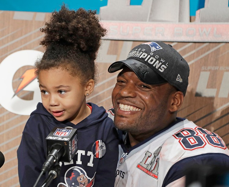 New England Patriots' Martellus Bennett appears at a news conference with his daughter Austyn Jett Rose Bennett after the team's epic Super Bowl victory Sunday in Houston. "I will not get inside the box society provides for everyone at birth," Bennett tweeted Tuesday. "And the box society sent for my daughter at birth we built a rocket ship out of it."