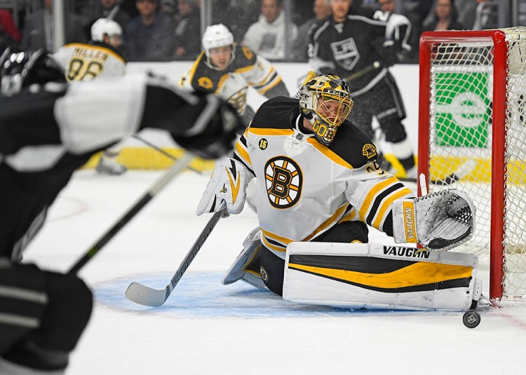 Boston Bruins goalie Anton Khudobin stops a shot by Los Angeles Kings defenseman Kevin Gravel, foreground left, during the second period of Thursday's game in Los Angeles. Khudobin was solid in just his ninth start of the season for the Bruins.