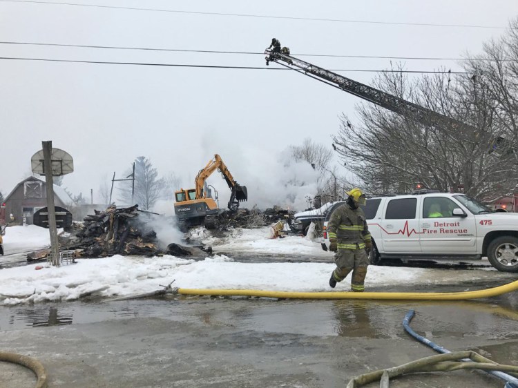 An excavator begins tearing down the remains of an apartment house on Square Road in Palmyra that was destroyed by fire early Tuesday morning, leaving two people dead and six others displaced but uninjured. 