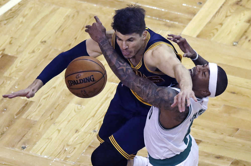Boston's Isaiah Thomas, right, and Cleveland's Kyle Korver collide while battling for the ball in the first quarter Wednesday night in Boston.
