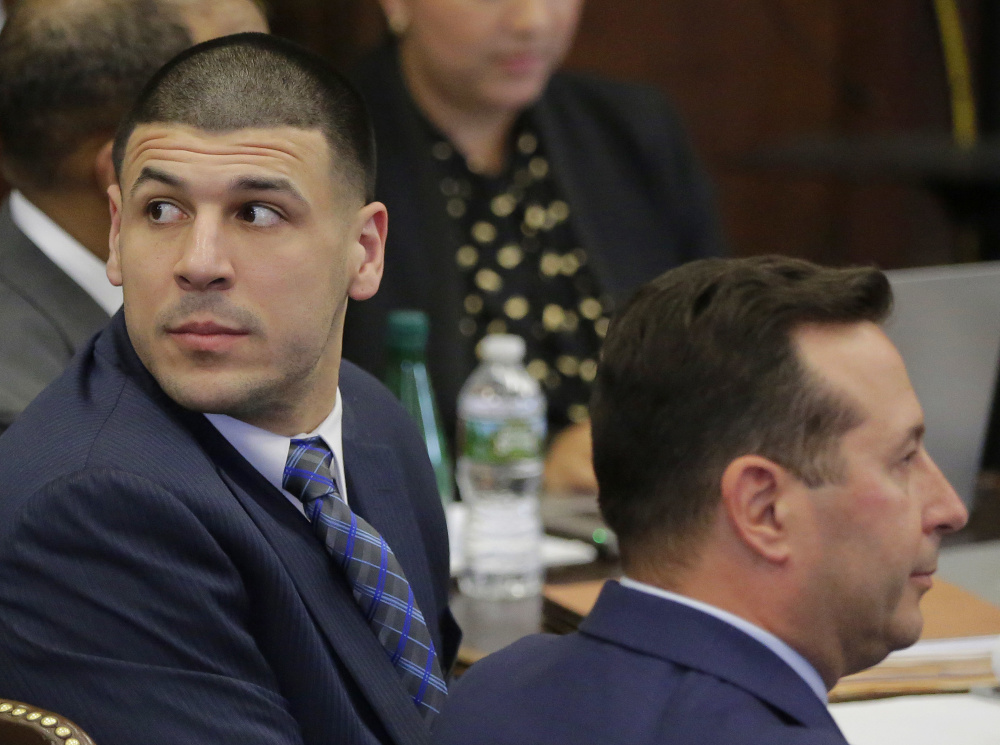 Former Patriots tight end Aaron Hernandez, left, looks toward the gallery on the first day of his double murder trial at Suffolk Superior Court in Boston on Wednesday.