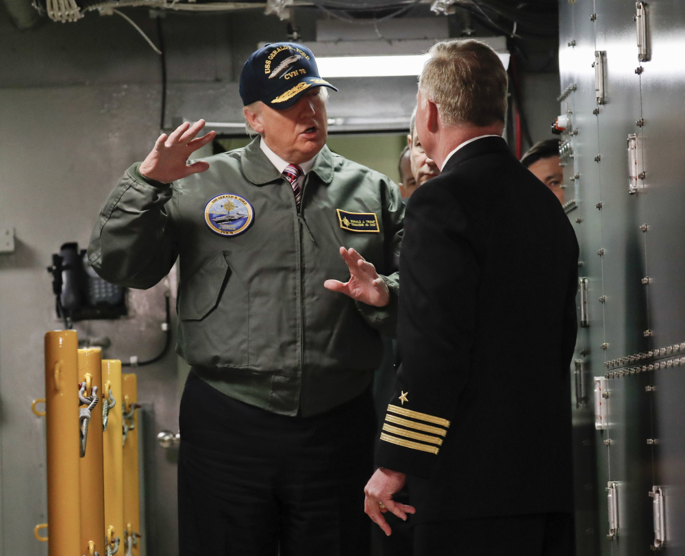 President Trump talks with Capt. Richard "Rick" McCormack during a tour of the nuclear aircraft carrier Gerald R. Ford on Thursday at Newport News Shipbuilding in Newport News, Va.