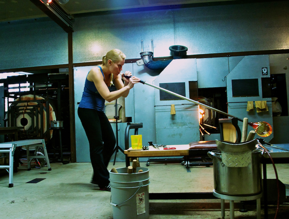 April Wagner works with a blow torch and hot glass in her Detroit, Mich., studio. The studio glass movement, which required a much smaller furnace to melt the glass, has made glass blowing more accessible and much more popular.