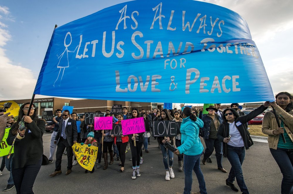 Hundreds of people march for peace Feb. 26 around the Ball Conference Center in Olathe, Kan., before starting a prayer vigil in response to the deadly shooting of two Indian men.