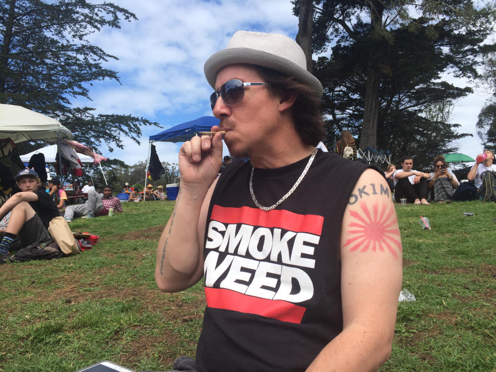 Shane Kinoshita smokes marijuana in Golden Gate Park as people gather to smoke pot for the annual 4/20 celebration in San Francisco, Calif., last April. A first-ever event sponsored this weekend by High Times magazine at a tribal events center near Las Vegas, Nev., will be smokeless after a U.S. attorney in Nevada warned the host Moapa Band of Paiutes that federal law applies on Indian reservations. The tribe declared that smoking, selling, trading and transporting marijuana won't be allowed.