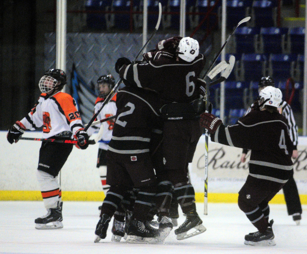 Greely players celebrate a first-period goal by Jake MacDonald that started the Rangers on their way to a 5-2 win over Gardiner in a Class B South semifinal Friday night at the Androscoggin Bank Colisee in Lewiston.