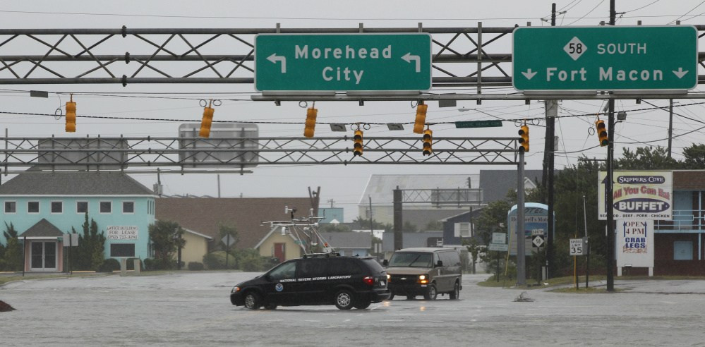 A NOAA storm vehicle turns around to avoid flood waters in Atlantic Beach, N.C., during Hurricane Irene in 2011. Proposed cuts would eliminate funding for some of the agency's smaller programs such as its "coastal resilience" initiative,  aimed at protecting coastlines.