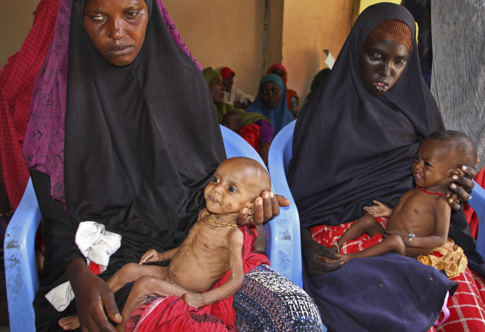 Malnourished baby Ali Hassan, left, is held by his mother, Fadumo Abdi Ibrahim, as mother Habiba Mohamed Aden holds her baby, Mohamud Ahmed, at a camp in Mogadishu.