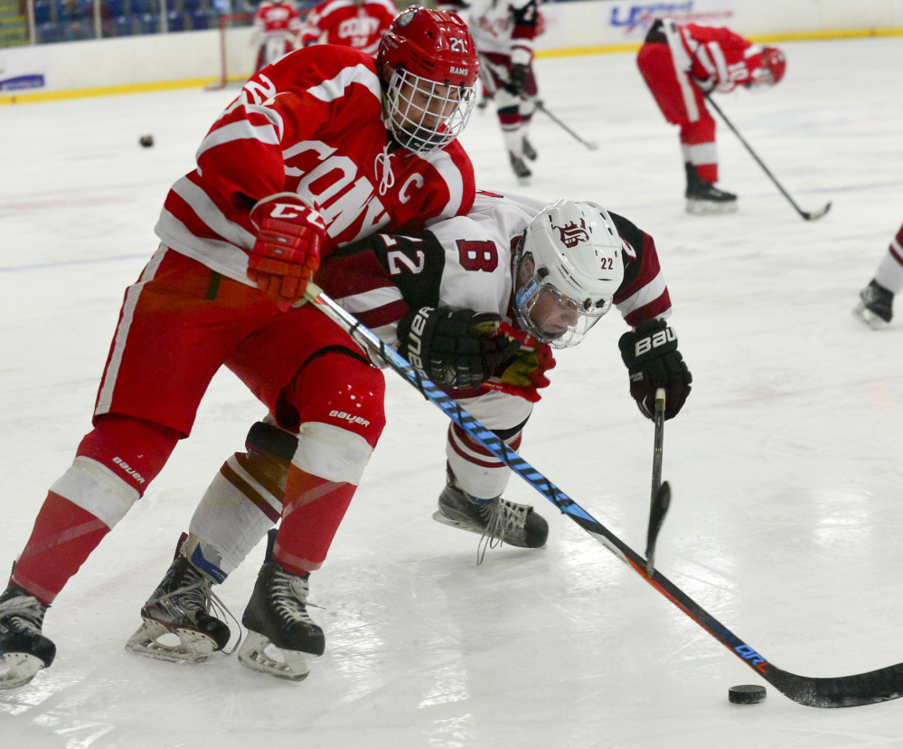 Thomas Arps of Cony collides with Bangor's Kodi Lagassie during a Class A North boys' hockey semifinal Saturday at the Androscoggin Bank Colisee in Lewiston. Bangor won, 2-1.