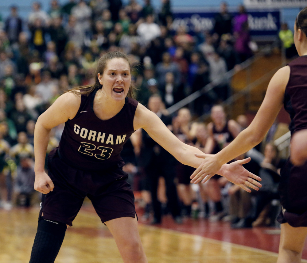 MARCH 4: Emily Esposito of Gorham celebrates with a teammate after scoring a basket during the Class AA girls' basketball state final Saturday against Oxford Hills. Esposito finished with 20 points, helping the Rams finish their second straight undefeated season.