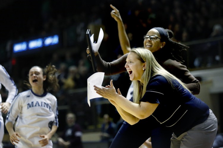 For players, some expressions aren't lost in translation. Coaches Amy Vachon, foreground, and Jasmine Player, cheer as the Black Bears increase their lead over Binghamton on Saturday. UMaine went on to win, 57-40.