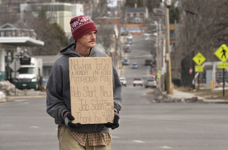 Dana Burnell panhandles on the median strip on Somerset Street in Portland late last month. But Burnell says he'd rather be working, and a pilot program called "Portland Opportunity Crew" could soon make that happen. It would also connect the city's most needy with social services.