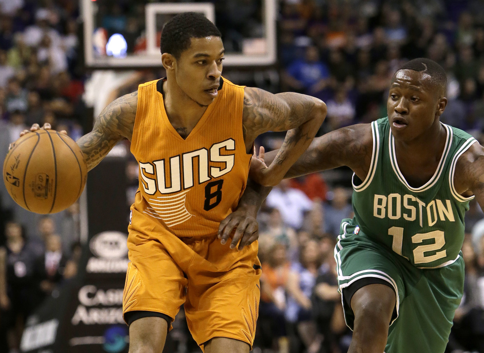 Phoenix guard Tyler Ulis, left, gets pressured by Celtics guard Terry Rozier in the second quarter of the Suns' 109-106 win on Sunday in Phoenix.