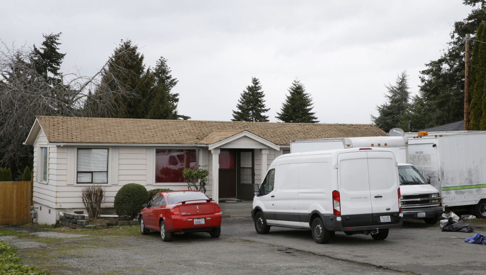 Vehicles sit parked Sunday at the home and driveway where a Sikh man was shot in the arm Friday in Kent, Wash. Authorities say a Sikh man said a gunman shot him as he worked on his car and told him "go back to your own country."