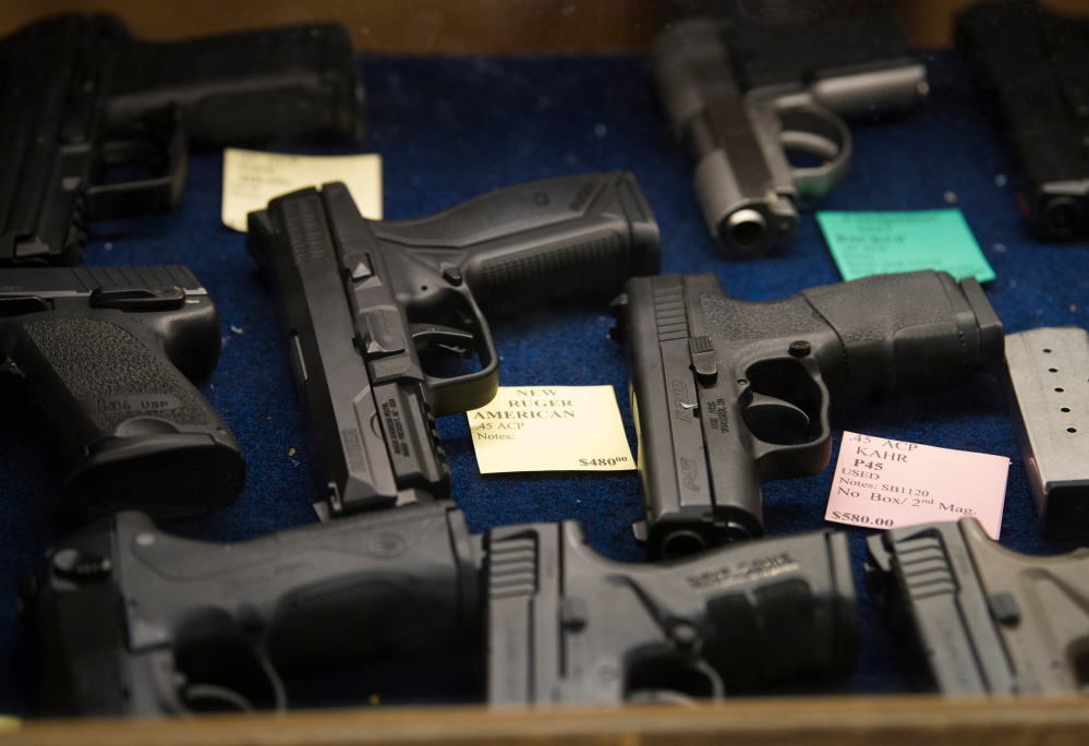 Pistols are for sale at the TargetMaster gun store and shooting range in Garland, Texas, on Friday.