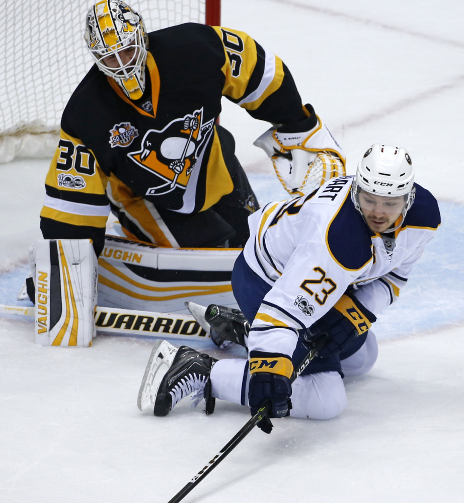 Buffalo Sabres' Sam Reinhart (23) reaches for a rebound in front of Pittsburgh Penguins goalie Matt Murray (30) in the first period of an NHL hockey game in Pittsburgh, Sunday, March 5, 2017. (AP Photo/Gene J. Puskar)