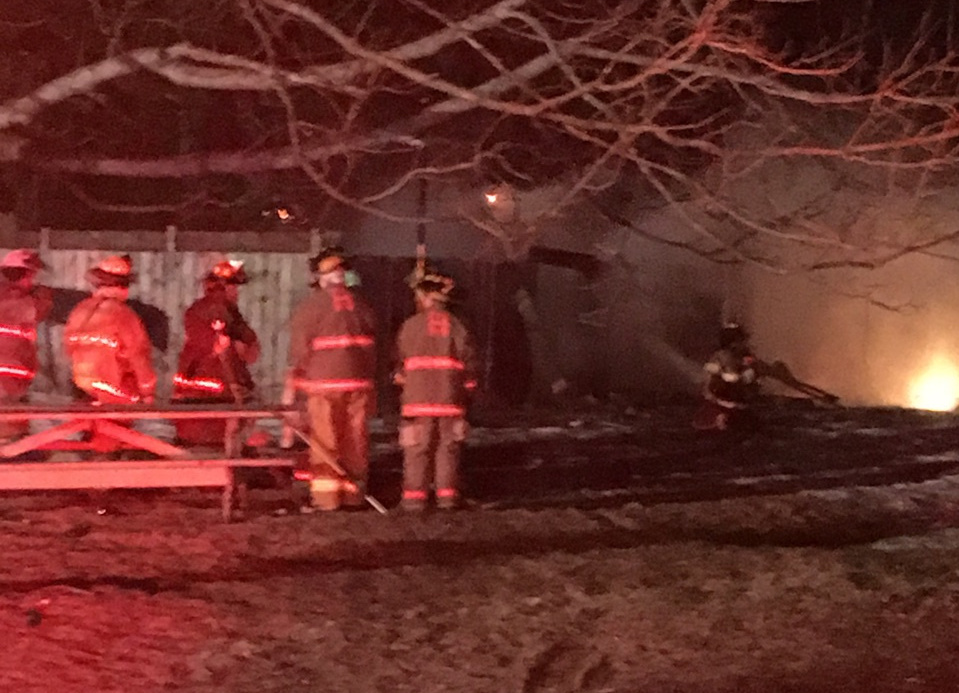 Firefighters from five communities battle a barn fire Sunday night in Hallowell. The blaze spread from a wood-burning stove used to make maple syrup inside the barn.