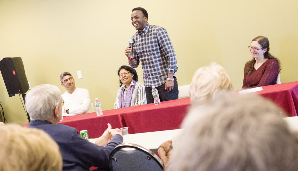 Somali immigrant Abdi Iftin speaks about learning English from Arnold Schwarzenegger movies and misconceptions he had about the United States before arriving 2   years ago during a panel discussion with Iraqi refugee Nawar Al Obaidi, left, and Cambodian refugee Makara Meng, second from left, led by the Holocaust and Human Rights Center of Maine Executive Director Elizabeth Helitzer, right, Monday in Augusta.