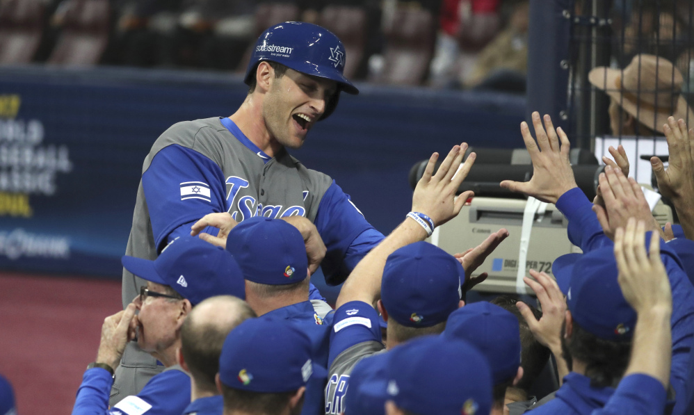 Israel's Nate Freiman celebrates with teammates after scoring on a bases-loaded walk in the second inning of a 2-1 first-round win over South Korea in the World Baseball Classic on Monday at Gocheok Sky Dome in Seoul, South Korea.