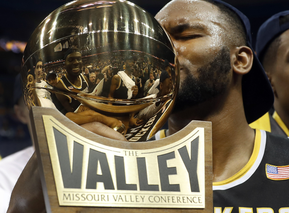 Wichita State's Shaquille Morris kisses the trophy after beating Illinois State 71-51 Sunday at St. Louis to win the Missouri Valley Conference tournament.