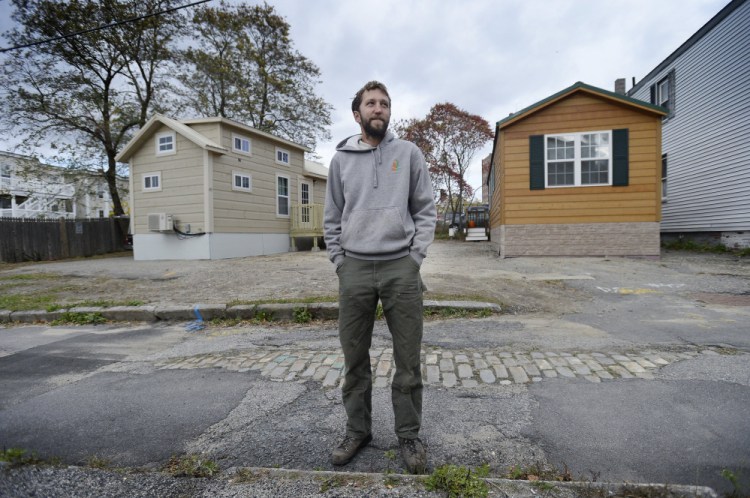 Brent Adler stands in October in front of the tiny houses he placed on Chapel Street. Attorney Nathaniel Huckel-Bauer, who is representing Adler's Federal Street Phoenix LLC, says the dispute with the city highlights the need to change local ordinances related to tiny houses.