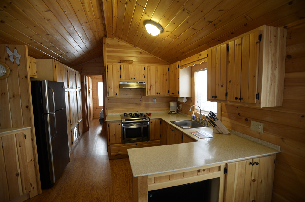 One of the tiny house units has handmade pine cabinets and wood laminate flooring.